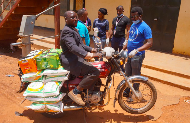Young African Refugees for Integral Development delivering food and other items in Kampala, Uganda